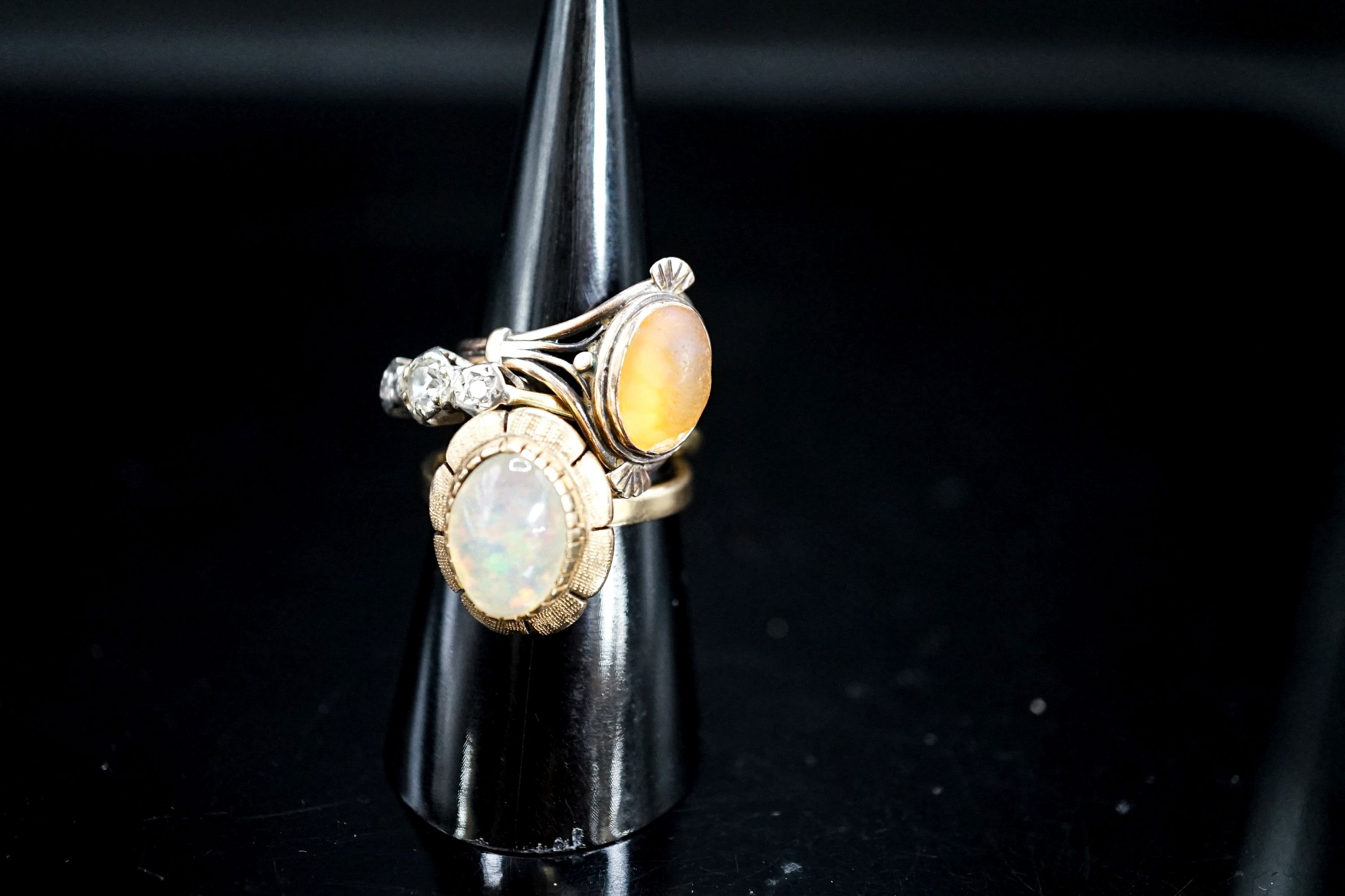 A yellow metal and illusion set three stone diamond ring, size P and two other yellow metal and gem set rings, gross 9.3 grams.